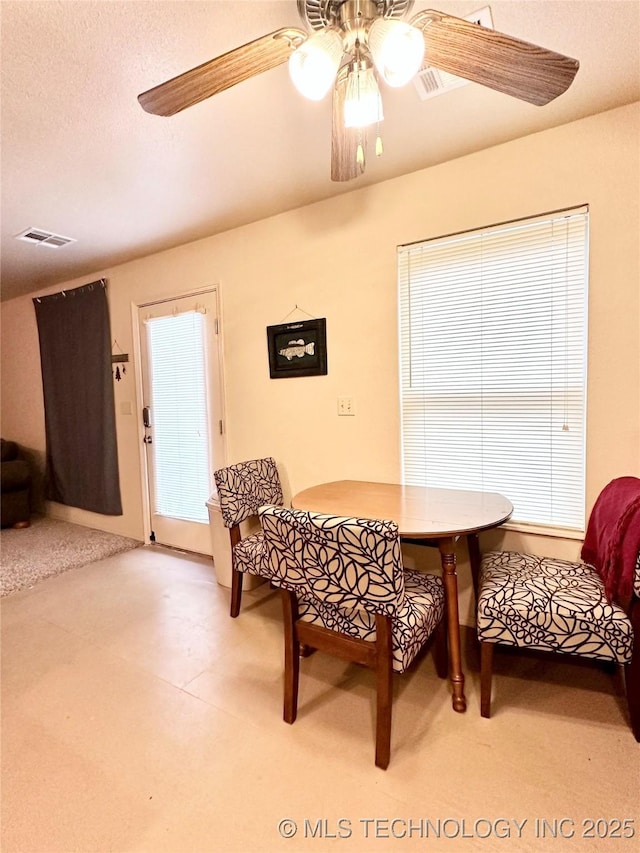 dining room featuring a textured ceiling and ceiling fan