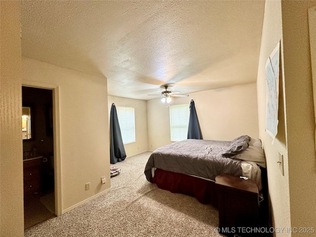 bedroom with ceiling fan, carpet, and a textured ceiling