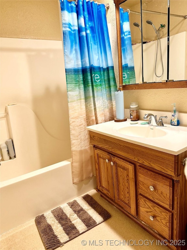 bathroom with shower / bath combo and vanity