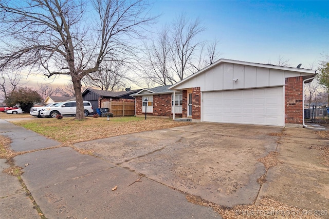 view of front of home with a garage and a lawn