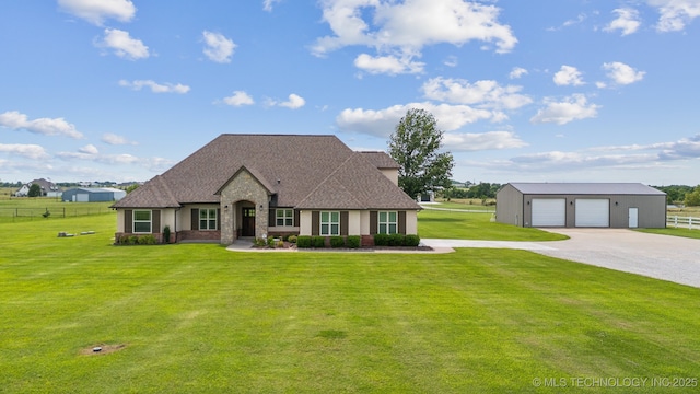 view of front of home with a garage and a front lawn