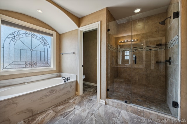 bathroom featuring independent shower and bath and toilet