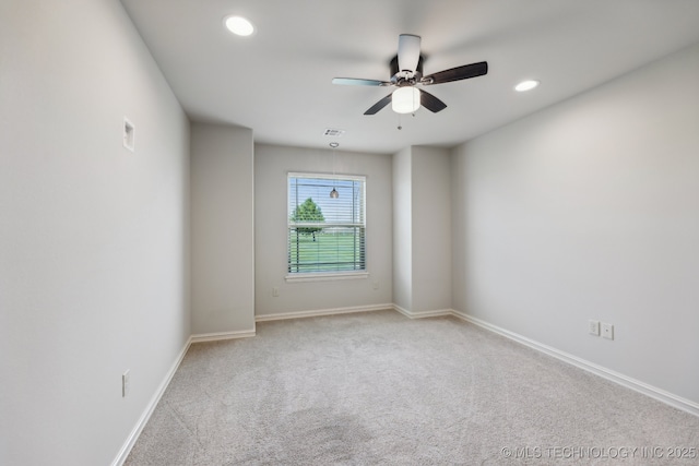 carpeted empty room featuring ceiling fan