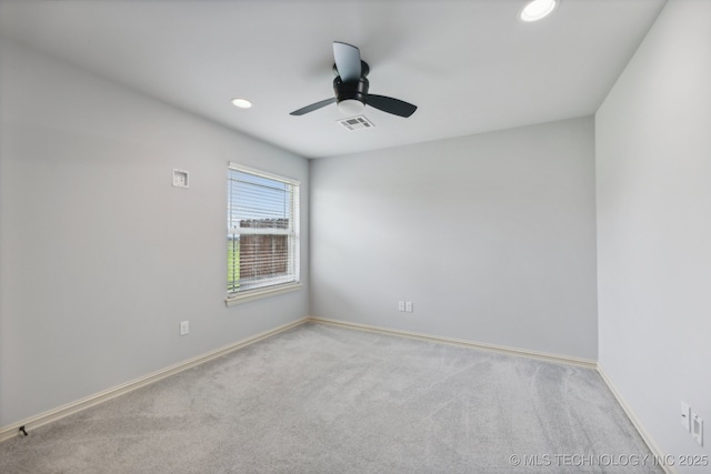 carpeted spare room with ceiling fan