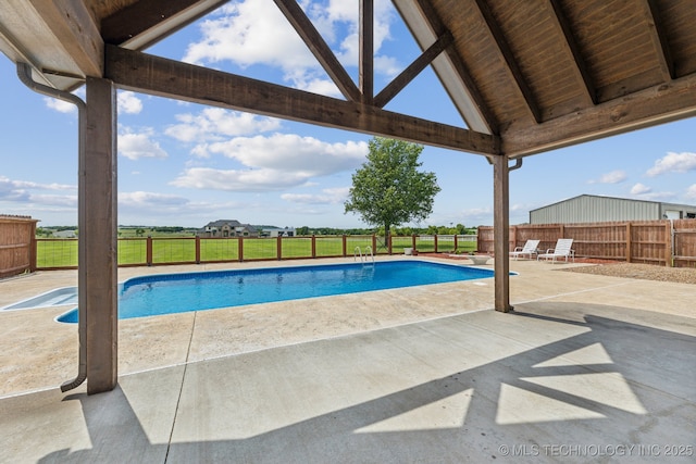 view of swimming pool with a patio area