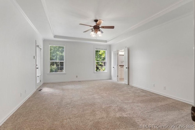 carpeted empty room with crown molding, ceiling fan, and a tray ceiling