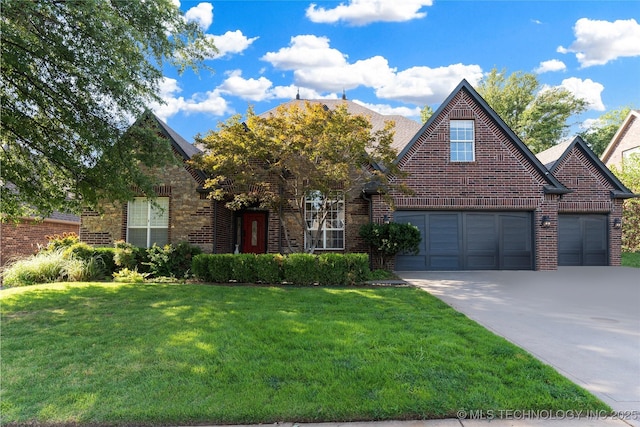 view of front of home with a garage and a front yard