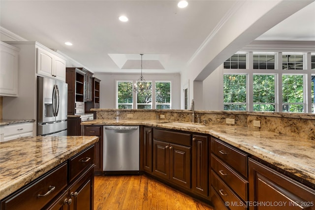 kitchen featuring dark brown cabinetry, stainless steel appliances, sink, and white cabinets