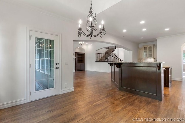 kitchen with decorative light fixtures, dark wood-type flooring, and a kitchen island