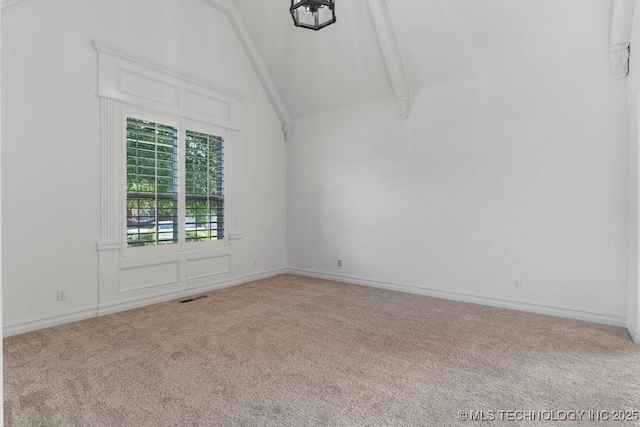 empty room featuring beamed ceiling, high vaulted ceiling, and carpet