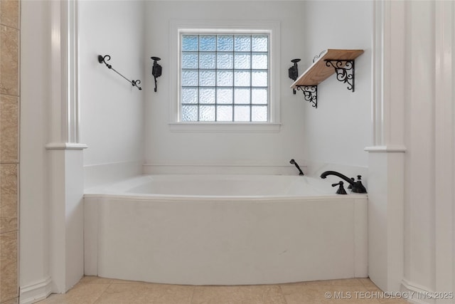 bathroom featuring tile patterned flooring and a tub