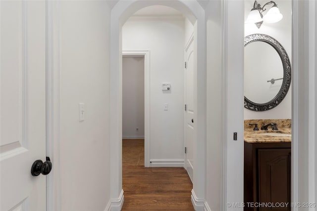 hall featuring dark hardwood / wood-style flooring and sink