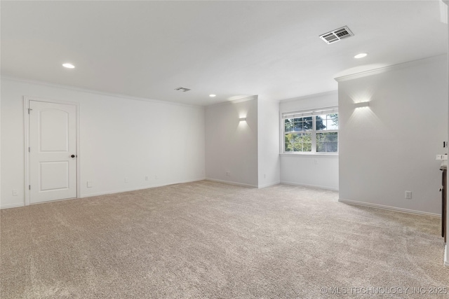 spare room with light carpet and crown molding