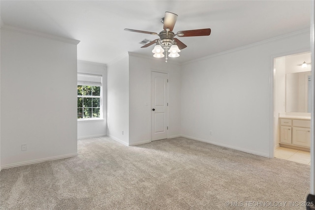 unfurnished bedroom featuring ceiling fan, light colored carpet, ornamental molding, and ensuite bath