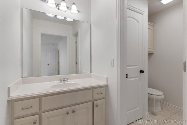 bathroom with tile patterned floors, toilet, and vanity