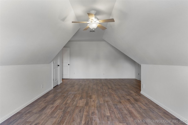 additional living space with vaulted ceiling, dark hardwood / wood-style floors, and ceiling fan