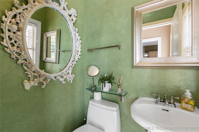 bathroom with toilet and sink