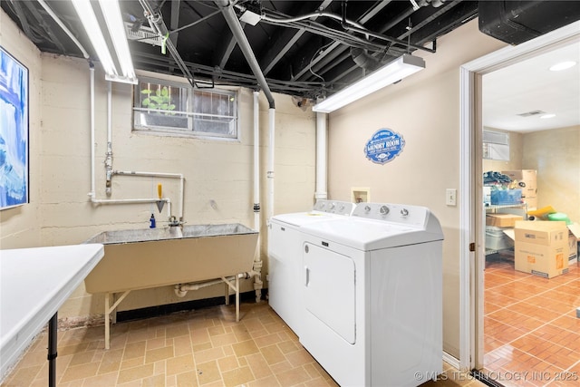 laundry area with sink and washing machine and clothes dryer