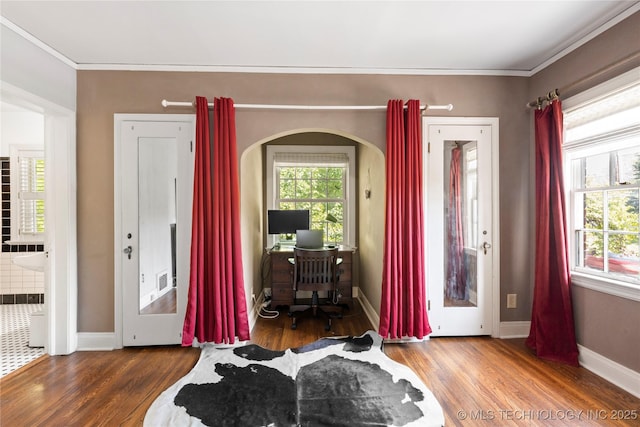 entryway with crown molding and wood-type flooring