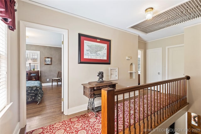 hall with hardwood / wood-style flooring and ornamental molding