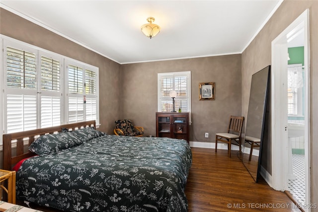 bedroom with crown molding and dark hardwood / wood-style floors