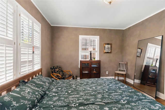 bedroom featuring hardwood / wood-style flooring and ornamental molding