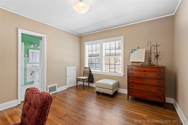 sitting room with crown molding, dark hardwood / wood-style flooring, and sink