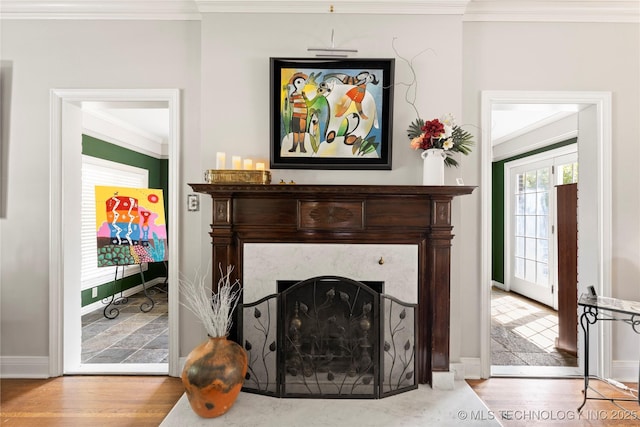 living room with crown molding, a fireplace, and light hardwood / wood-style flooring