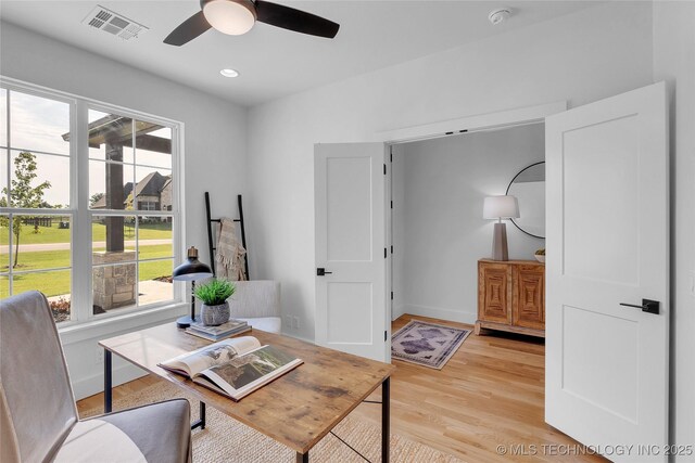 home office featuring ceiling fan and light hardwood / wood-style flooring