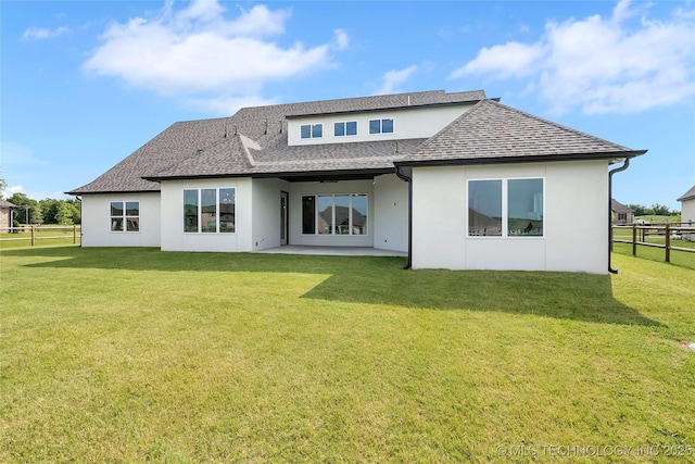 back of house with a yard and a patio area