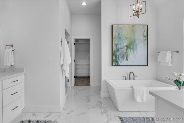 bathroom with vanity and a bath