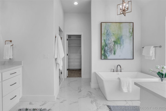 bathroom with a tub to relax in and vanity