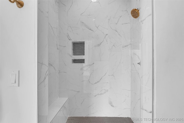 bathroom with tiled shower