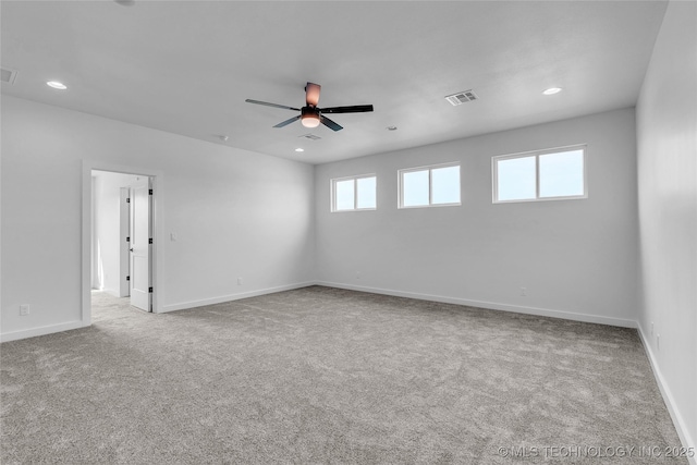 unfurnished room featuring ceiling fan and light colored carpet