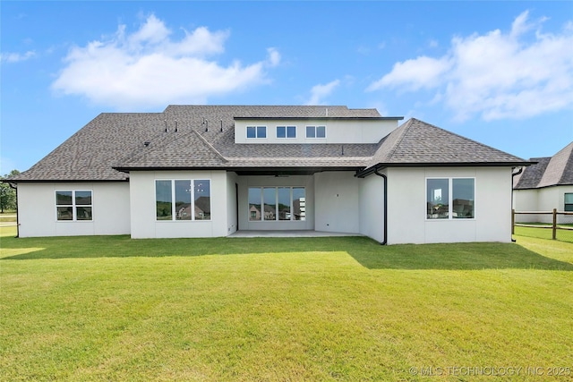 rear view of house with a yard and a patio