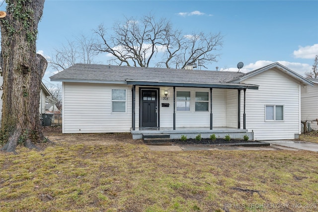 ranch-style home with a porch and a front lawn