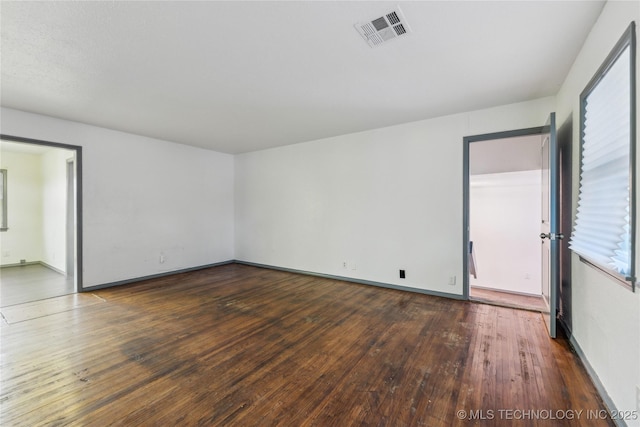 unfurnished room with dark hardwood / wood-style flooring