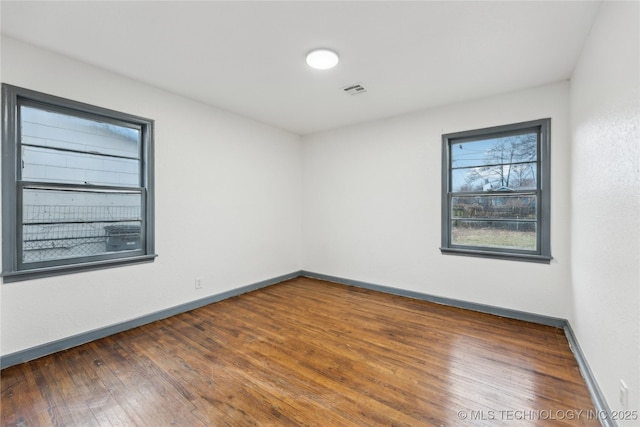 unfurnished room featuring dark hardwood / wood-style flooring