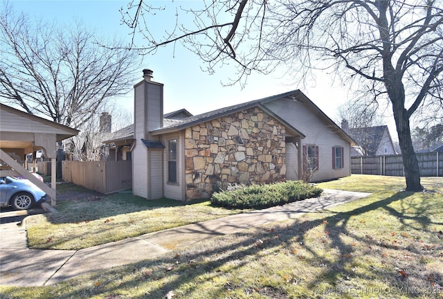 view of side of home with a yard