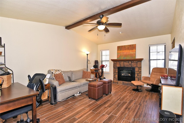 living room with a stone fireplace, vaulted ceiling with beams, and ceiling fan