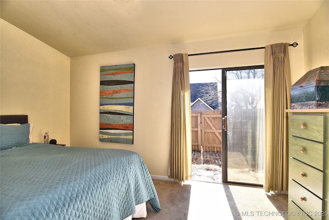 carpeted bedroom featuring access to outside