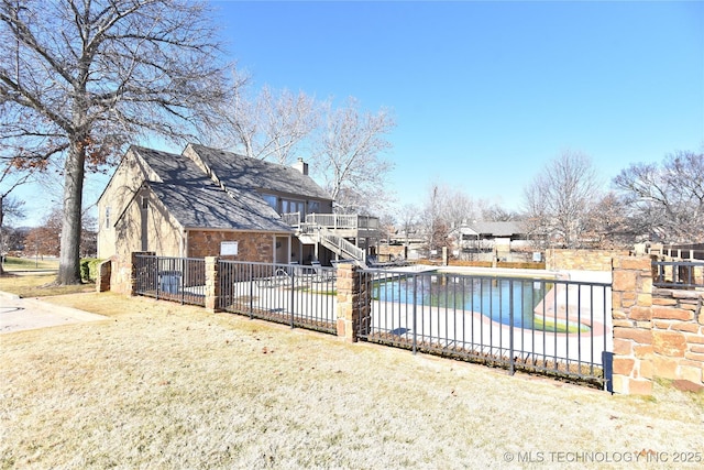 view of swimming pool featuring a patio and a lawn