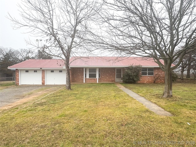 ranch-style house with a garage and a front lawn