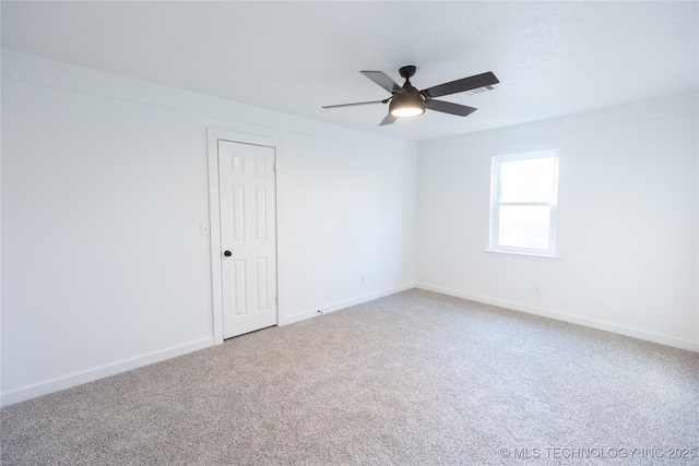 empty room with a textured ceiling, ceiling fan, and carpet flooring