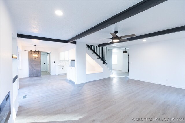 7850 S Park Ave, Broken Arrow, OK 74011 - unfurnished living room featuring beam ceiling, stairs, recessed lighting, light wood finished floors, and baseboards