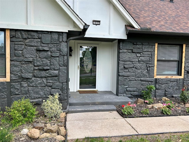 7850 S Park Ave, Broken Arrow, OK 74011 - view of exterior entry with stone siding and a shingled roof