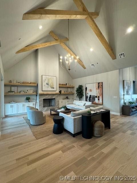 living room with beamed ceiling, high vaulted ceiling, a chandelier, and light hardwood / wood-style flooring