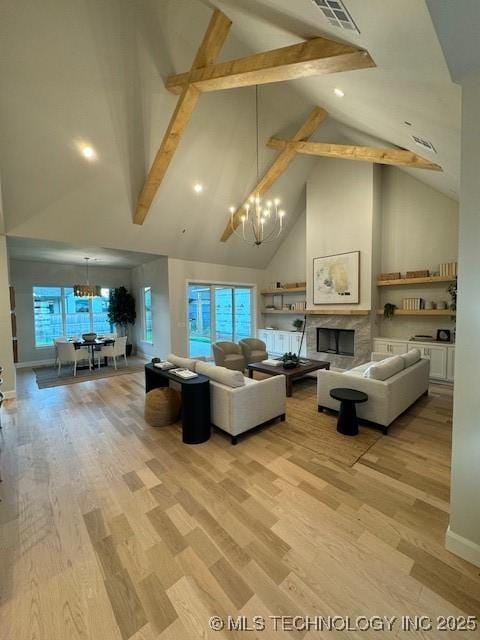 living room with high vaulted ceiling, beam ceiling, light hardwood / wood-style floors, and a notable chandelier