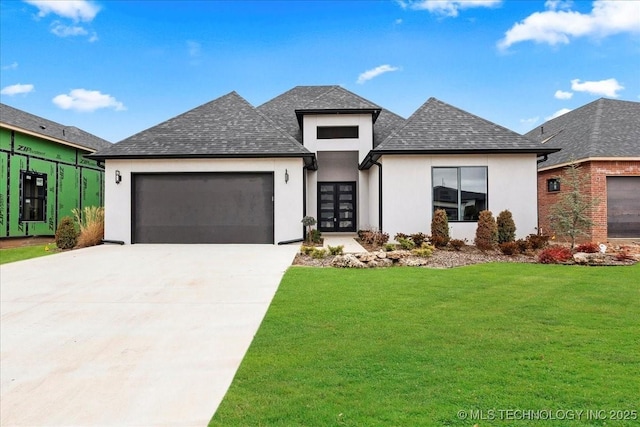 view of front of property featuring a garage and a front yard