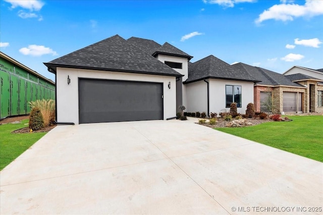 view of front of house featuring a garage and a front lawn